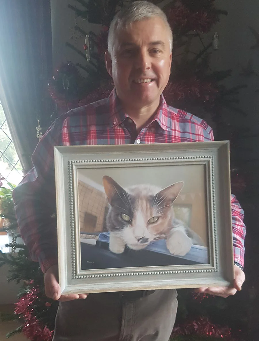 Client Andrew with Mitzy’s portrait on Christmas Day, a heartwarming photo.