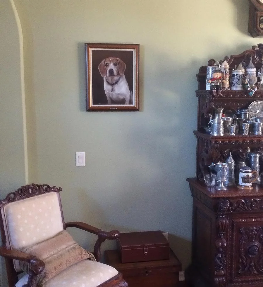 Client display of the framed Beagle oil portrait of Christopher in a home setting.
