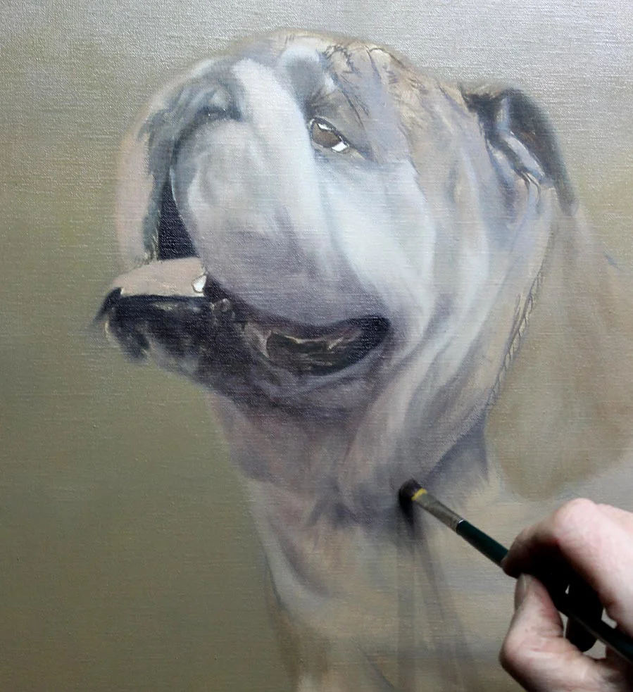 Oil portrait of Remington the Bulldog on an artist's easel in a studio.