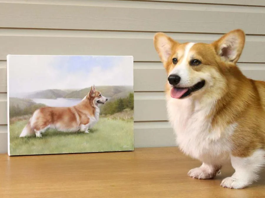 Corgi Luke posing beside his oil painting, looking at the camera.