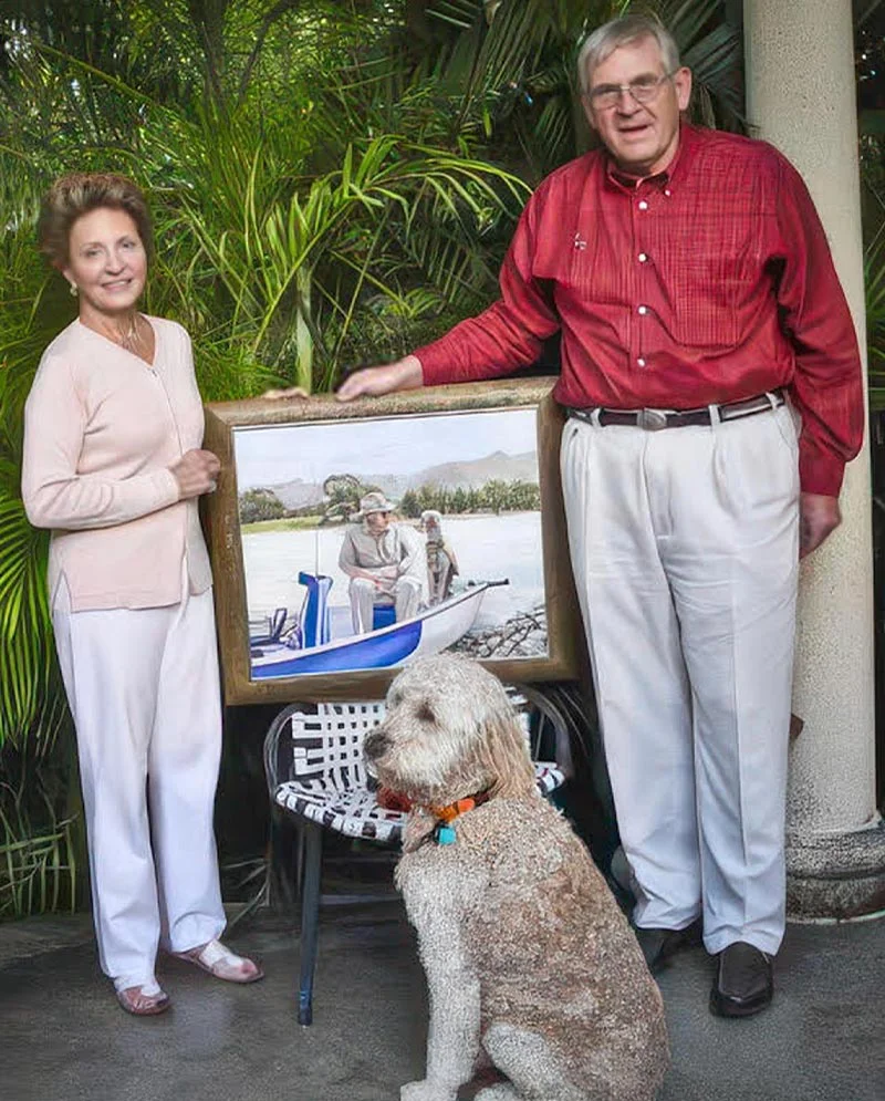 Happy clients proudly holding the finished oil painting of Henry and Daisy, showcasing the portrait in their home.