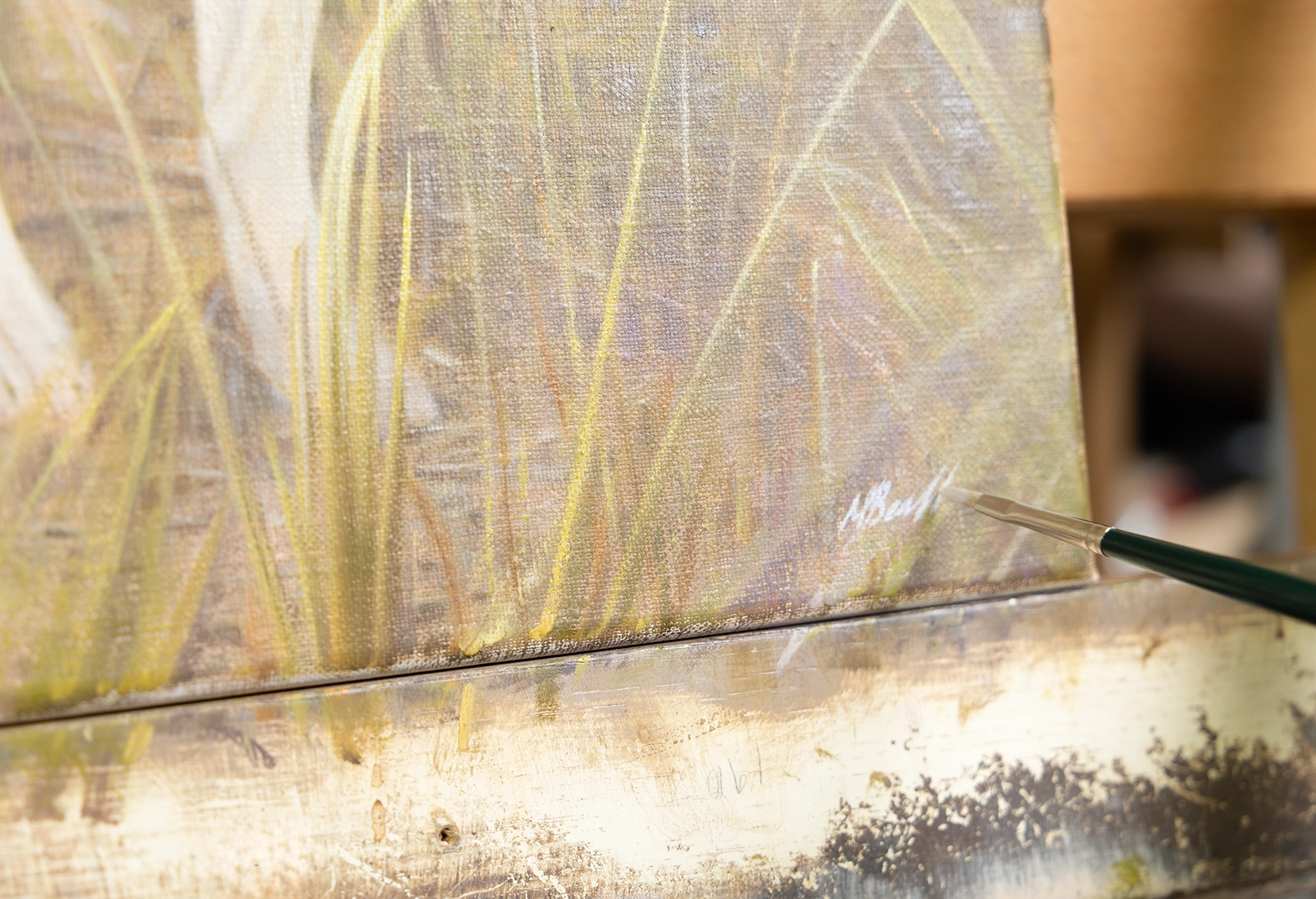 Nicholas signing an oil painting in depth guide to pet portrait pricing