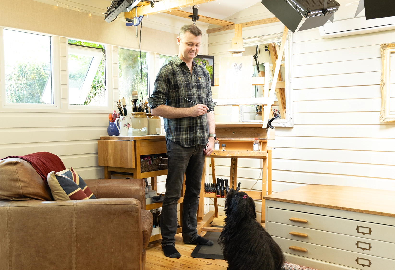 Nicholas Beall by his painting easel in his studio.