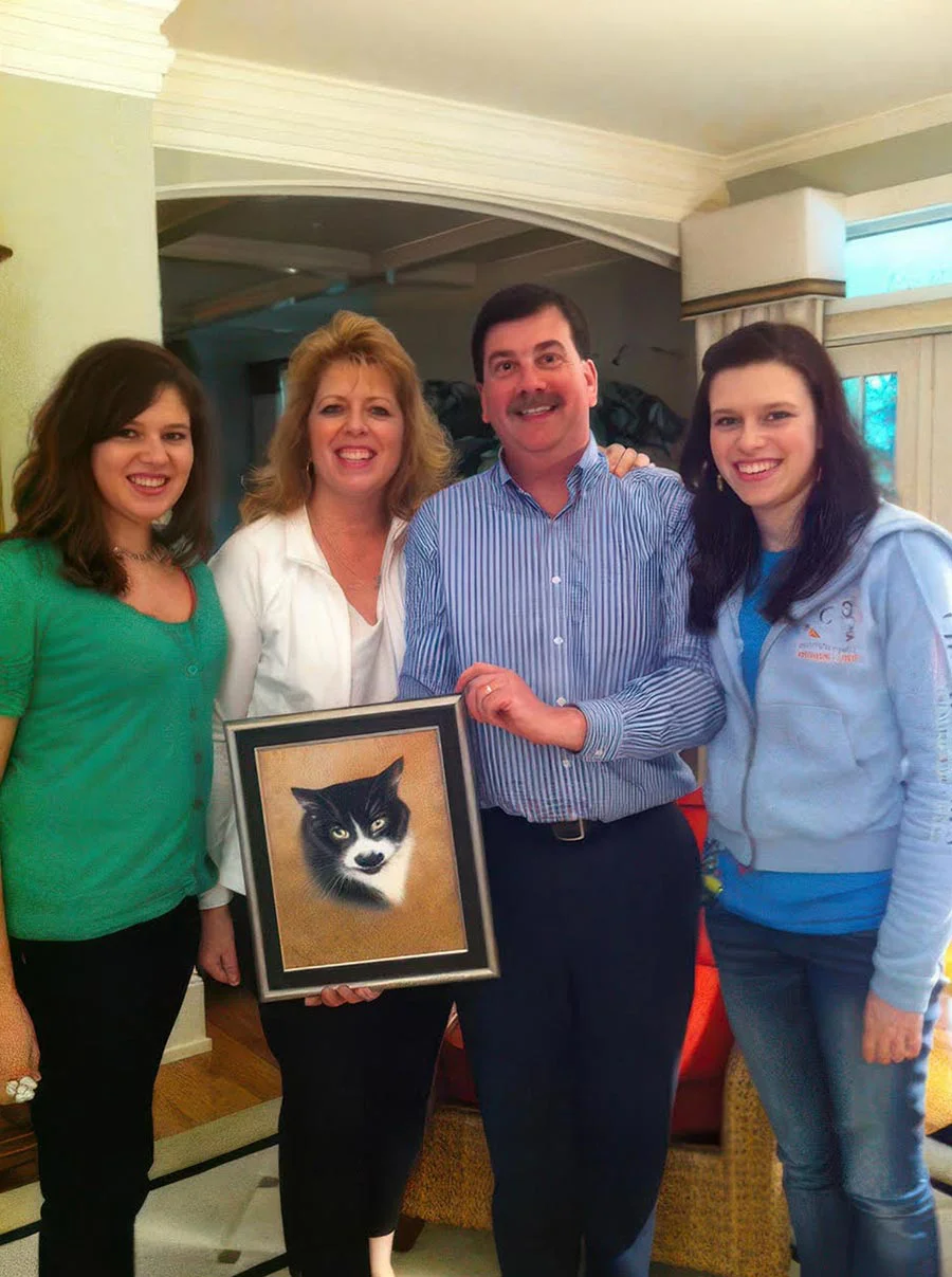 Groucho: Memorial oil painting of the cat, a heartfelt gift for his family Family gathered around a memorial oil portrait of their black and white cat, Groucho