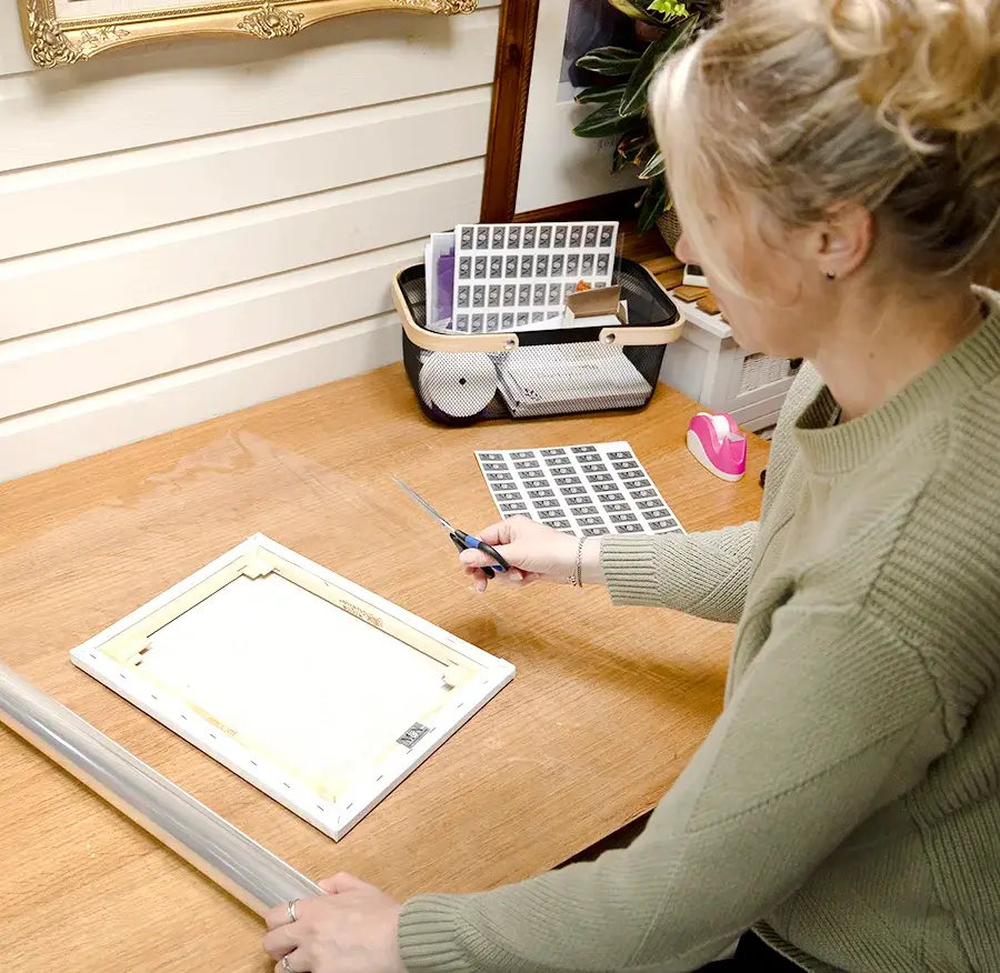 Protective tissue paper being placed over pet portrait