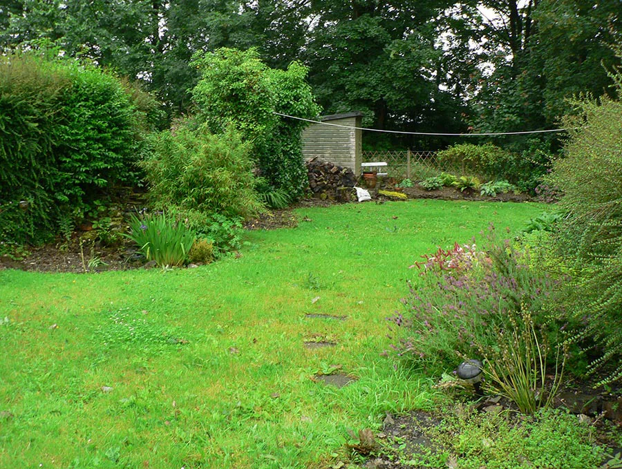 Welsh Cottage Garden Before Landscaping The Welsh cottage garden in 2007, showing a simple rectangular lawn bordered by overgrown shrubs before landscaping began.