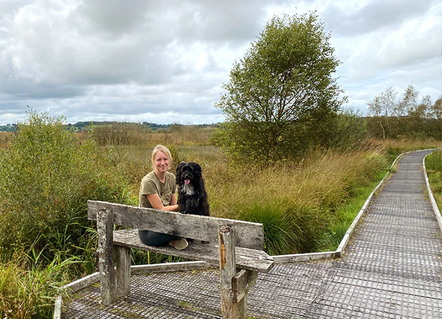 Melanie Phillips and Lily the Tibetan Terrier walking on the Tregaron wildlife boardwalk.