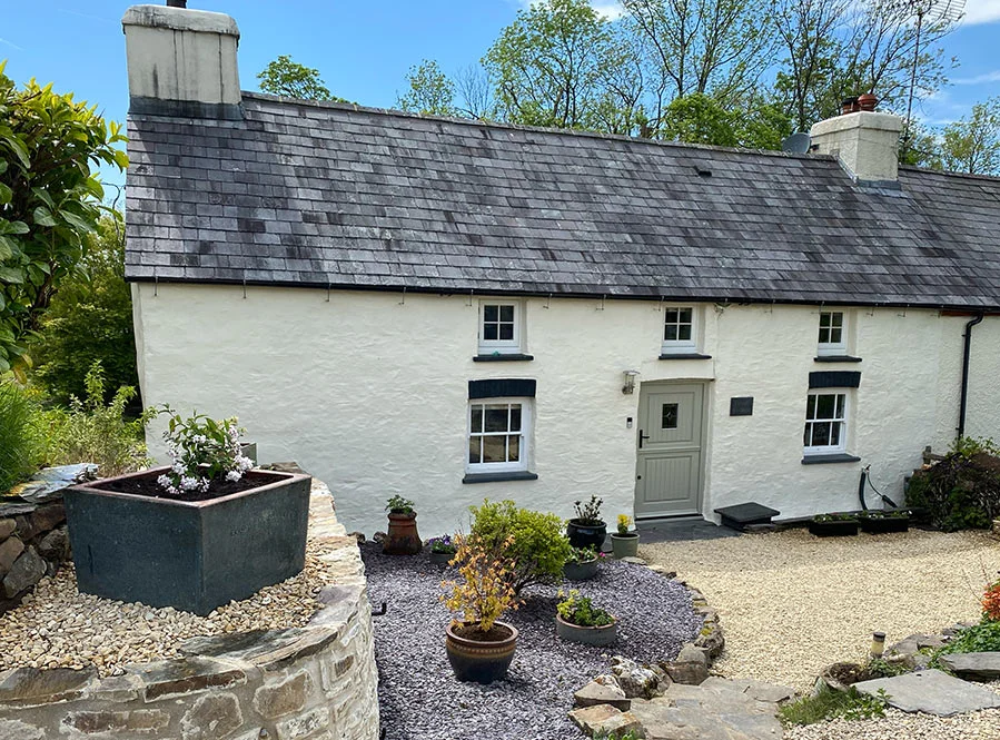 Our Welsh Cottage The charming, renovated Welsh stone cottage, home to Nicholas and Melanie, nestled in the countryside.