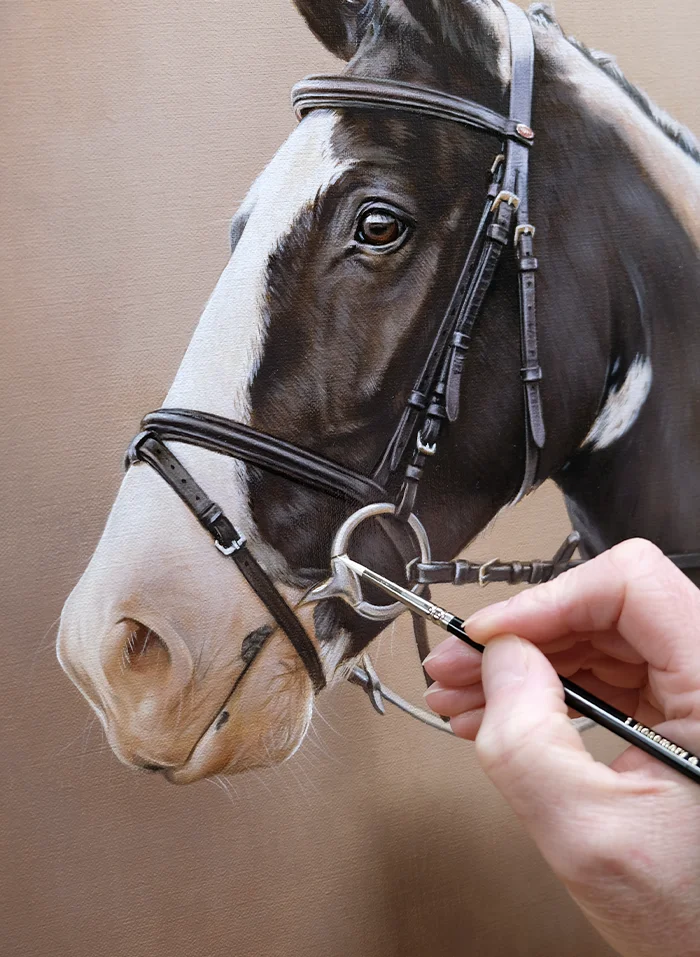 Nicholas Beall working on an oil painting of a horse.