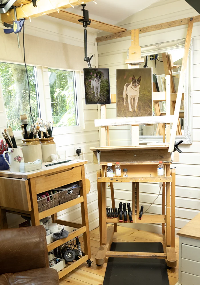 Nicholas's iPad mounted to a studio beam, used for displaying large reference photos at eye level while painting.