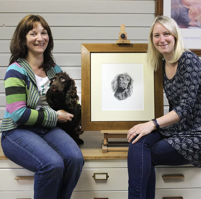 Tracey collecitng per pencil drawing of Moo at our studio with moo the dog.