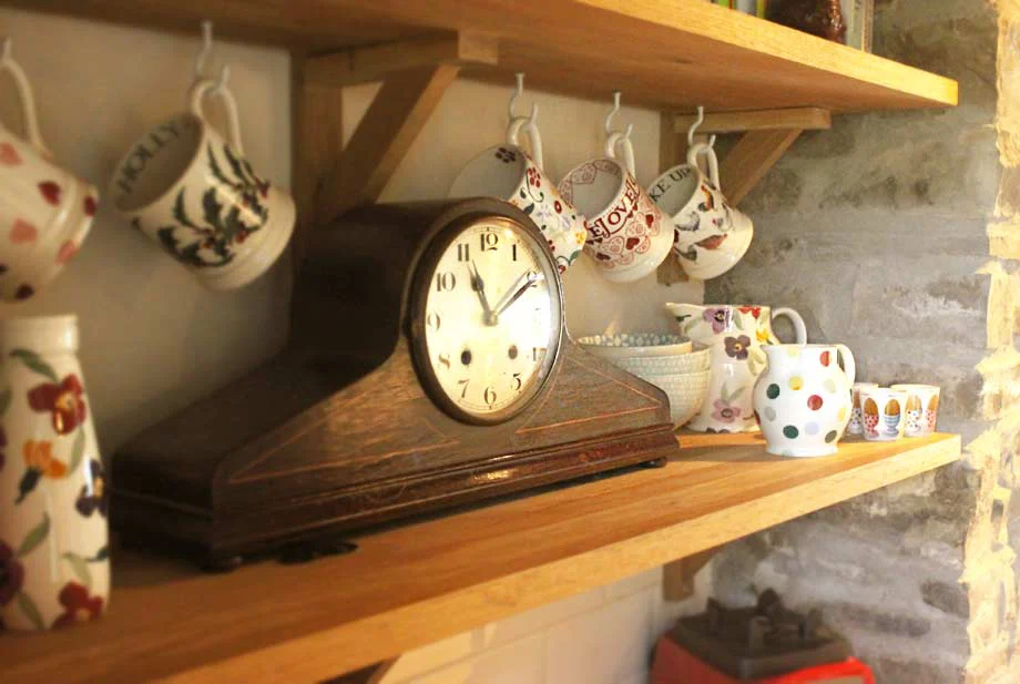 Vintage Clock in Kitchen Vintage 1950s Napoleon hat clock, a gift from a neighbor, displayed in the Welsh cottage kitchen.