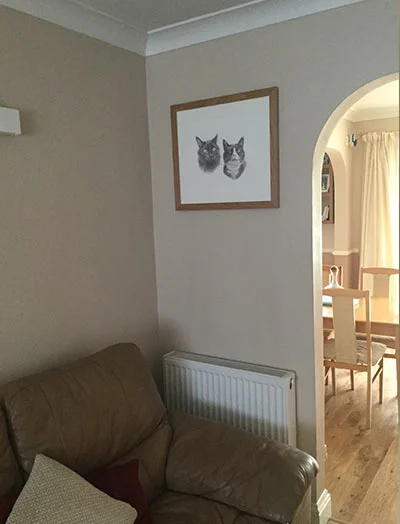 Julie's Cat Portrait in Situ A framed cat portrait displayed prominently on a wall in a client's home, chosen for its significant size.